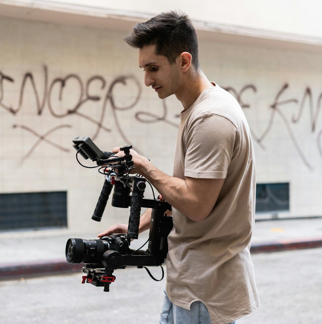 Camera operator adjusting a broadcast camera on a studio crane